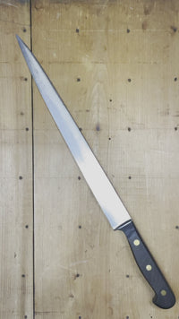Drop forged and hand ground (and hand ground again) German slicer from approximately the 1960's (or early 70's) judging from the non-forged straight tang and brass rivets but with solid wood handle scales. Hand ground carbon steel knives like this largely ended in the mid 1970's in Solingen Germany being supplanted by stainless steel and less hand grinding.