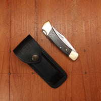 Buck 110 Folding Hunter 3 3/4” Clip Point 420HC Lockback Ebony Handle with Leather Sheath